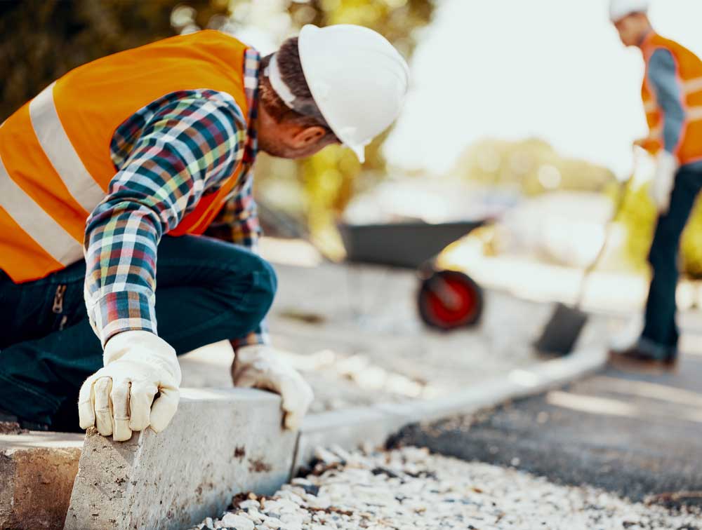 Worker Arranging Curbs on Street | US Dept of Homeland Security | A James Global